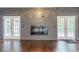 Gray accent wall with built-in shelving and a modern fireplace at 9635 Haverhill Ln, Johns Creek, GA 30022