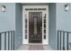 Elegant black front door with sidelights and a welcoming mat at 9635 Haverhill Ln, Johns Creek, GA 30022
