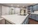 Large kitchen island with white countertop and cooktop at 9635 Haverhill Ln, Johns Creek, GA 30022