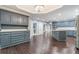 Open kitchen with gray cabinets and hardwood floors at 9635 Haverhill Ln, Johns Creek, GA 30022