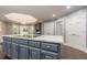 Modern kitchen with gray cabinets, quartz countertops, and a large island at 9635 Haverhill Ln, Johns Creek, GA 30022