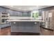 Modern kitchen with gray cabinets, white countertops, and stainless steel appliances at 9635 Haverhill Ln, Johns Creek, GA 30022
