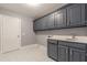 Laundry room with gray cabinets and white countertop at 9635 Haverhill Ln, Johns Creek, GA 30022