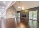 Spacious living room featuring hardwood floors, a fireplace, and access to a deck at 9635 Haverhill Ln, Johns Creek, GA 30022