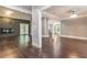 Open living room with dark hardwood floors and fireplace at 9635 Haverhill Ln, Johns Creek, GA 30022
