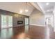 Open living area with hardwood floors and a vaulted ceiling at 9635 Haverhill Ln, Johns Creek, GA 30022