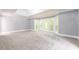 Large bedroom with gray walls, new carpet, and bay windows at 9635 Haverhill Ln, Johns Creek, GA 30022