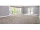 Spacious main bedroom with gray walls, carpeting and private access to deck at 9635 Haverhill Ln, Johns Creek, GA 30022