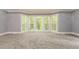 Bright bedroom with gray walls, new carpet and access to a deck at 9635 Haverhill Ln, Johns Creek, GA 30022