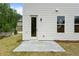 Home backyard with concrete patio, exterior door, well-maintained lawn, and view of neighborhood at 711 Smokey Quartz Way, Kennesaw, GA 30144
