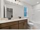 Bathroom features double sink vanity with modern fixtures, bathtub and window at 711 Smokey Quartz Way, Kennesaw, GA 30144