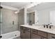 Bathroom featuring dual sinks, quartz countertops, and a glass shower at 711 Smokey Quartz Way, Kennesaw, GA 30144