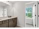 Bathroom featuring dual sinks and a view out the window at 711 Smokey Quartz Way, Kennesaw, GA 30144