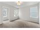 Bright bedroom featuring neutral walls, carpeted flooring, and two windows for natural light at 711 Smokey Quartz Way, Kennesaw, GA 30144