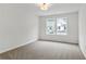 Bright bedroom featuring new carpet and a view out the window at 711 Smokey Quartz Way, Kennesaw, GA 30144