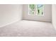 Well-lit bedroom with carpet flooring and two windows at 711 Smokey Quartz Way, Kennesaw, GA 30144