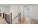Well-lit hallway featuring a staircase and an open view to a bedroom with a ceiling fan at 711 Smokey Quartz Way, Kennesaw, GA 30144