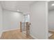 Bright hallway with wood floors and wood banister at 711 Smokey Quartz Way, Kennesaw, GA 30144