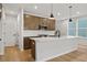 Stylish kitchen with a white countertop island, stainless steel appliances, and plenty of natural light from the window at 711 Smokey Quartz Way, Kennesaw, GA 30144