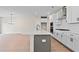 Modern kitchen with white cabinets, quartz countertops, and island at 711 Smokey Quartz Way, Kennesaw, GA 30144