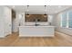 Bright, open kitchen featuring a large island, stainless steel appliances, and modern pendant lighting at 711 Smokey Quartz Way, Kennesaw, GA 30144
