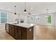 Open concept kitchen and living area with a kitchen island and a fireplace, ideal for entertaining at 711 Smokey Quartz Way, Kennesaw, GA 30144