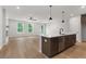 Open concept kitchen with a large island, stainless steel appliances and hardwood floors at 711 Smokey Quartz Way, Kennesaw, GA 30144