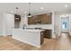 Open kitchen features a large center island, stainless appliances and hardwood floors at 711 Smokey Quartz Way, Kennesaw, GA 30144