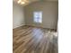 Spacious living room with wood-look floors at 1914 Grant Ln, Woodstock, GA 30188