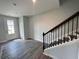 Two-story entryway with gray vinyl plank flooring and an iron staircase at 1352 Creekside Nw Cir, Atlanta, GA 30318