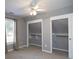 Bedroom with two large closets and ceiling fan at 7425 Ivy Grove St, Cumming, GA 30040