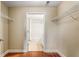 Walk-in closet with built-in shelving leading to a full bathroom at 230 E Ponce De Leon Ave # 317, Decatur, GA 30030