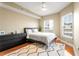 Bedroom with hardwood floors, large windows, and dark dresser at 230 E Ponce De Leon Ave # 317, Decatur, GA 30030