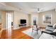 Living room features hardwood floors, gray sofa, and access to balcony at 230 E Ponce De Leon Ave # 317, Decatur, GA 30030