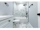 Modern bathroom with marble shower and white fixtures at 2353 Hembree Sw Rd, Marietta, GA 30064