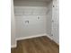 Bright laundry room with wire shelving and vinyl flooring at 4076 E Glade Ct, Decatur, GA 30035