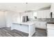 Modern kitchen with white cabinets, gray backsplash, and large island at 1362 Creekside Nw Cir, Atlanta, GA 30318