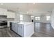 Open concept kitchen with island, gray cabinets, and stainless steel appliances at 1362 Creekside Nw Cir, Atlanta, GA 30318