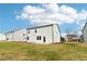 A shot of the backyard of a two-story home showing new construction and a well-maintained lawn at 7289 Eton Ln, Locust Grove, GA 30248