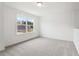 Bedroom featuring neutral carpet and a window at 7289 Eton Ln, Locust Grove, GA 30248