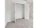 Walk in closet with shelving, neutral carpeting, and a standard sized door at 7289 Eton Ln, Locust Grove, GA 30248