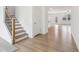 Bright entryway with hardwood floors, staircase, and an open layout to the living area creating a spacious and inviting atmosphere at 7289 Eton Ln, Locust Grove, GA 30248