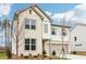 Beautiful new construction home featuring a brick and siding exterior with a two-car garage and manicured landscaping at 7289 Eton Ln, Locust Grove, GA 30248