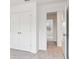 A standard sized hallway features neutral carpeting and white doors at 7289 Eton Ln, Locust Grove, GA 30248