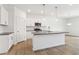 Modern kitchen with stainless steel appliances, a large island, and white cabinets offering style and functionality at 7289 Eton Ln, Locust Grove, GA 30248