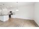 Open-concept kitchen and dining area with stainless steel appliances, hardwood floors and a seamless flow, perfect for entertaining at 7289 Eton Ln, Locust Grove, GA 30248