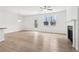 Bright, open living room featuring wood floors, a fireplace, and a ceiling fan at 7289 Eton Ln, Locust Grove, GA 30248