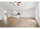 Bright living room with hardwood floors, a ceiling fan, and ample natural light creating a comfortable and inviting space at 7289 Eton Ln, Locust Grove, GA 30248