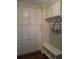 Functional laundry room with white cabinets and storage bench at 3463 Lee St, Smyrna, GA 30080