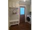 Laundry room with built-in cabinets, a bench, and modern appliances at 3463 Lee St, Smyrna, GA 30080